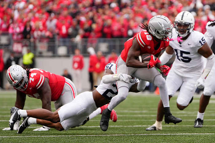 Oct 21, 2023; Columbus, Ohio, USA; Ohio State Buckeyes wide receiver Marvin Harrison Jr. (18) drags Penn State Nittany Lions safety Kevin Winston Jr. (21) during the second half of the NCAA football game at Ohio Stadium. Ohio State won 20-12.